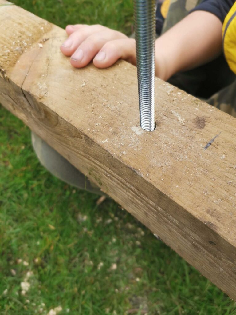 180mm coach bolt going through the rear log store frame.