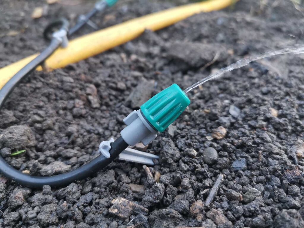 Drip emitter automatically watering greenhouse by the power of gravity alone