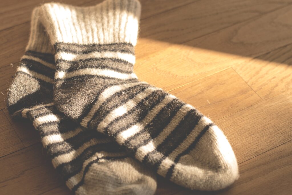 Woollen socks on a wooden floor.