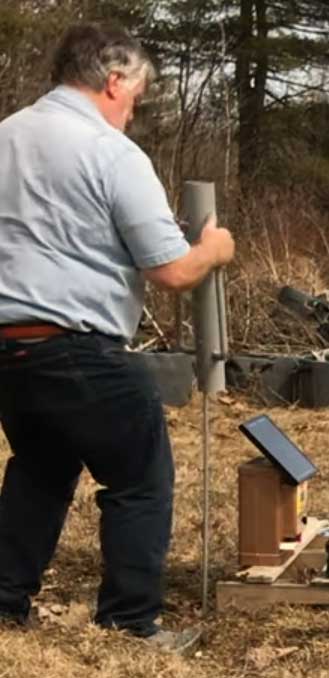Fence post driver being used to drive grounding rods into the earth for an electric chicken fence