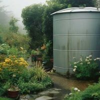 Rainwater harvesting storage tank in an English country garden