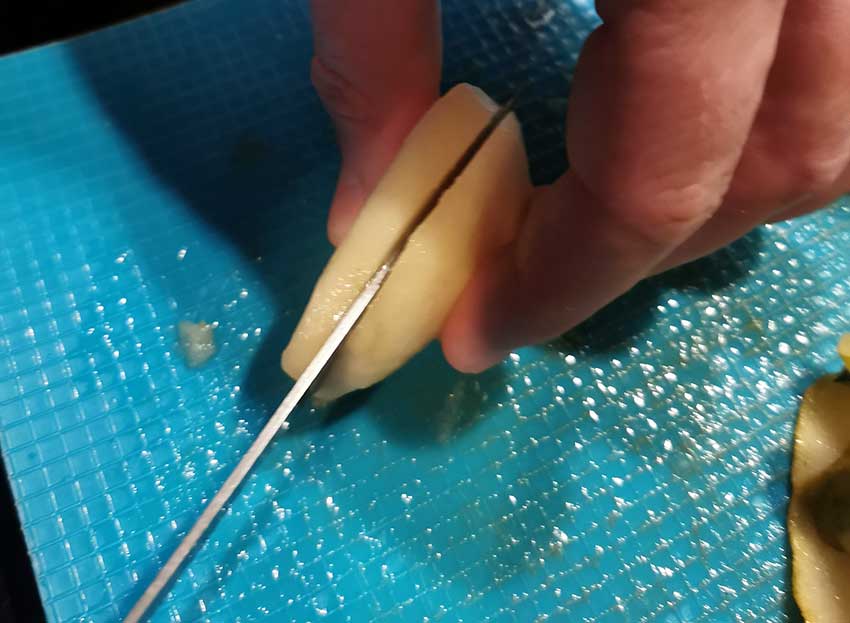 Slicing peeled pears to about 5mm thickness for an even dry